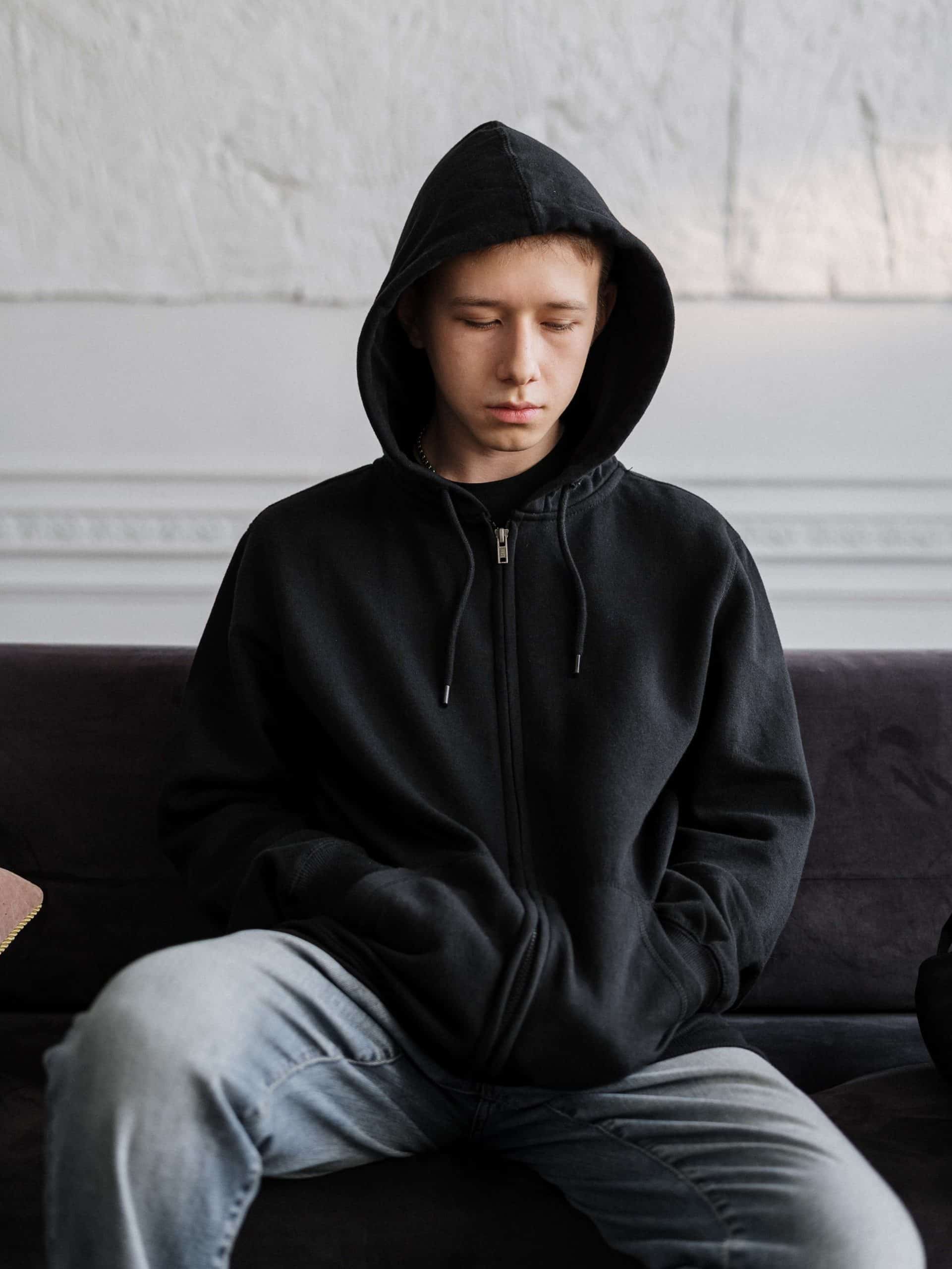 Early Maladaptive Schemas - photo of young adult male in black hoodie looking down